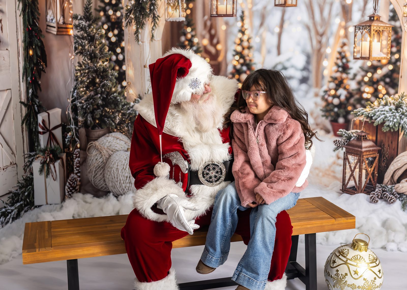 Santa Michael sharing a quiet moment with a young girl in his winter studio